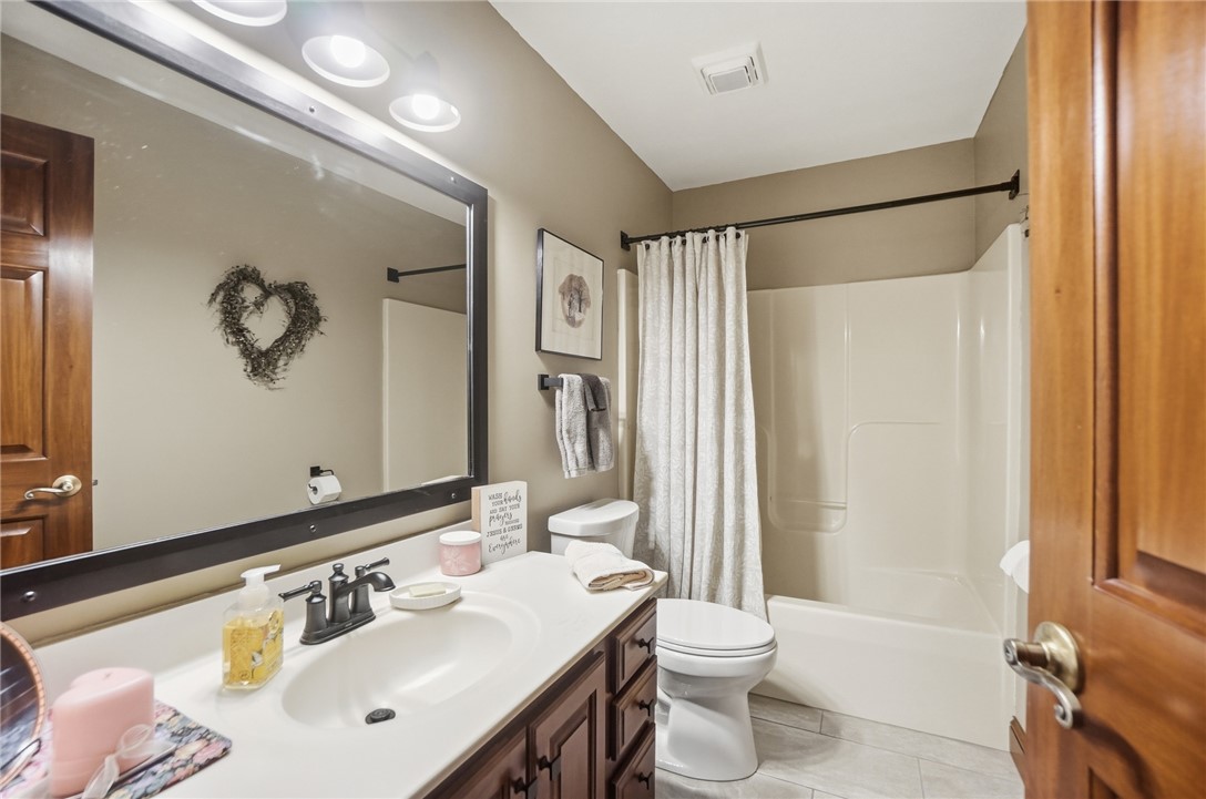 5300 Brookshire Lane Springfield, OH 45502 - Photo 39 of 56 This clean and inviting bathroom features a single vanity, a standard toilet, and a combined shower-tub unit.
