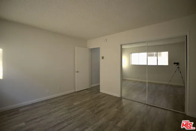 a view of wooden floor and windows in a room