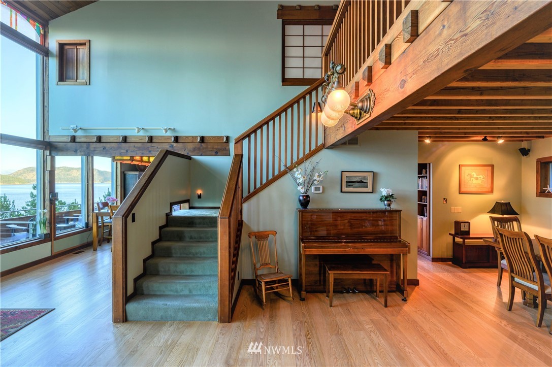 14114 Ervine Road Anacortes, WA 98221 - Photo 11 of 40 a view of entryway dining room and hall with wooden floor