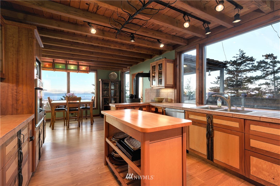 14114 Ervine Road Anacortes, WA 98221 - Photo 12 of 40 a view of a kitchen with kitchen island a large window in it