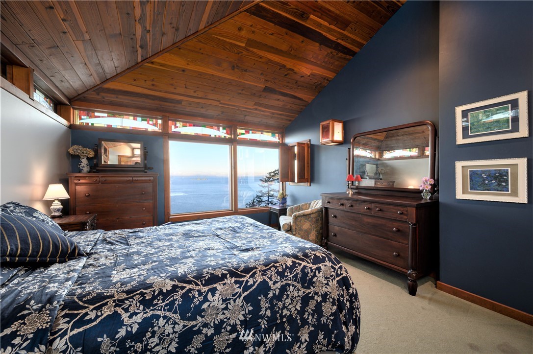 14114 Ervine Road Anacortes, WA 98221 - Photo 16 of 40 a bedroom with a bed and wooden floor