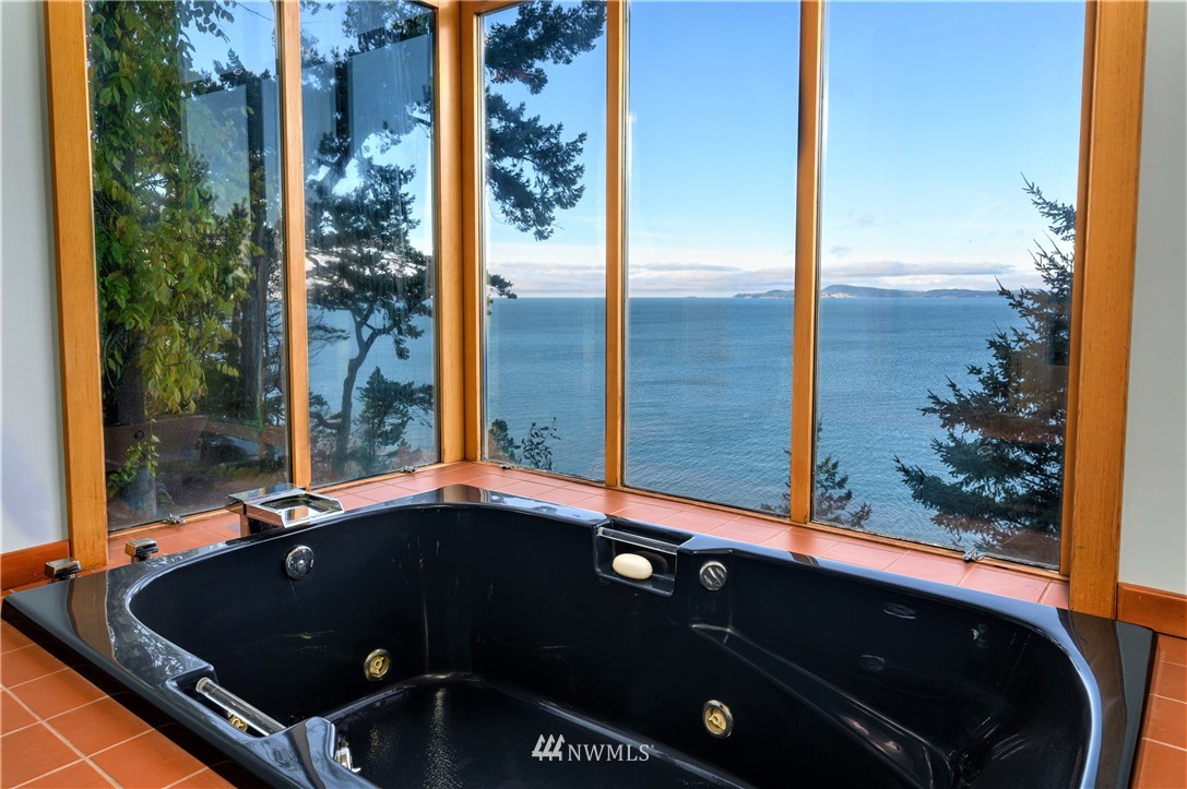 14114 Ervine Road Anacortes, WA 98221 - Photo 18 of 40 a living room with a large window and potted plants