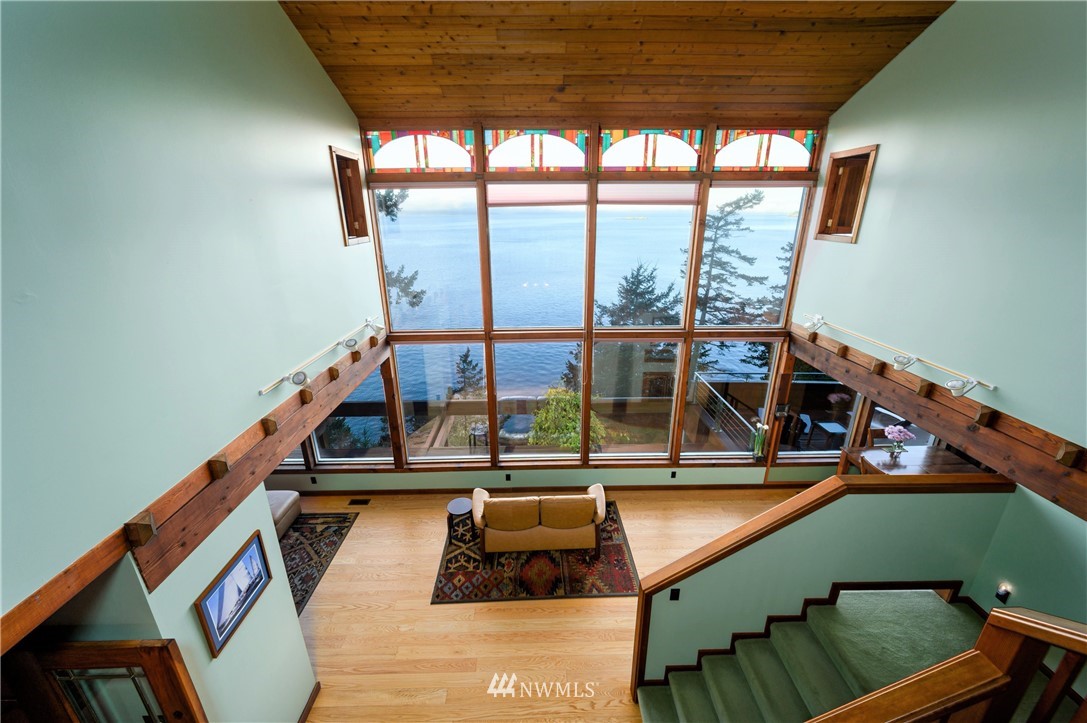 14114 Ervine Road Anacortes, WA 98221 - Photo 7 of 40 a view of a balcony with floor to ceiling windows with wooden floor