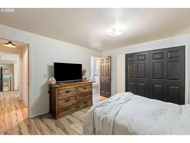 a bedroom with a bed and a flat screen tv