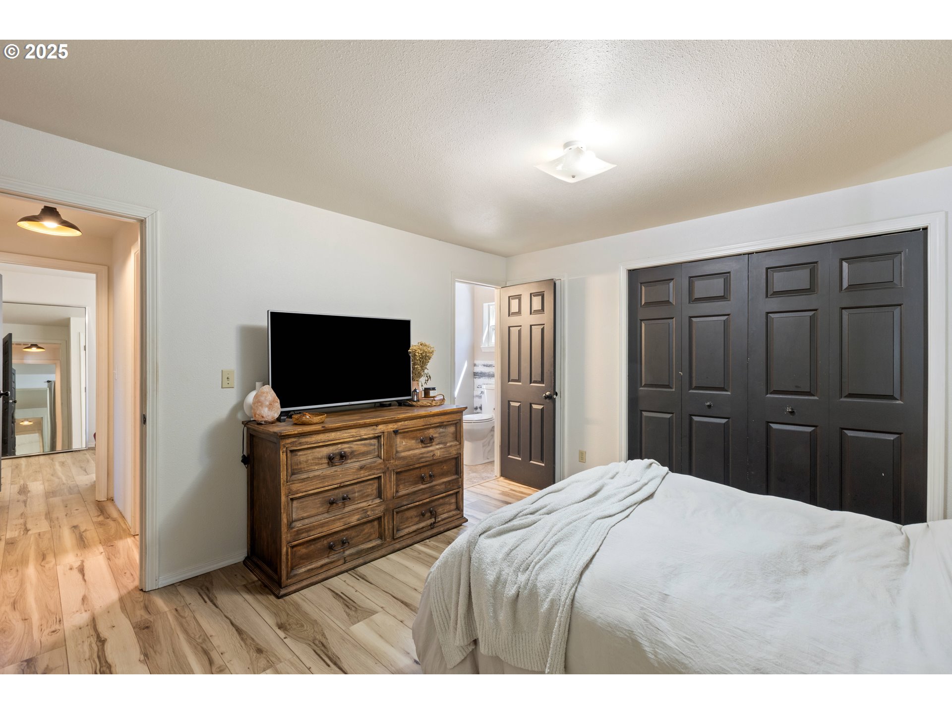 187 Hackett Lane Riddle, OR 97469 - Photo 11 of 48 a bedroom with a bed and a flat screen tv