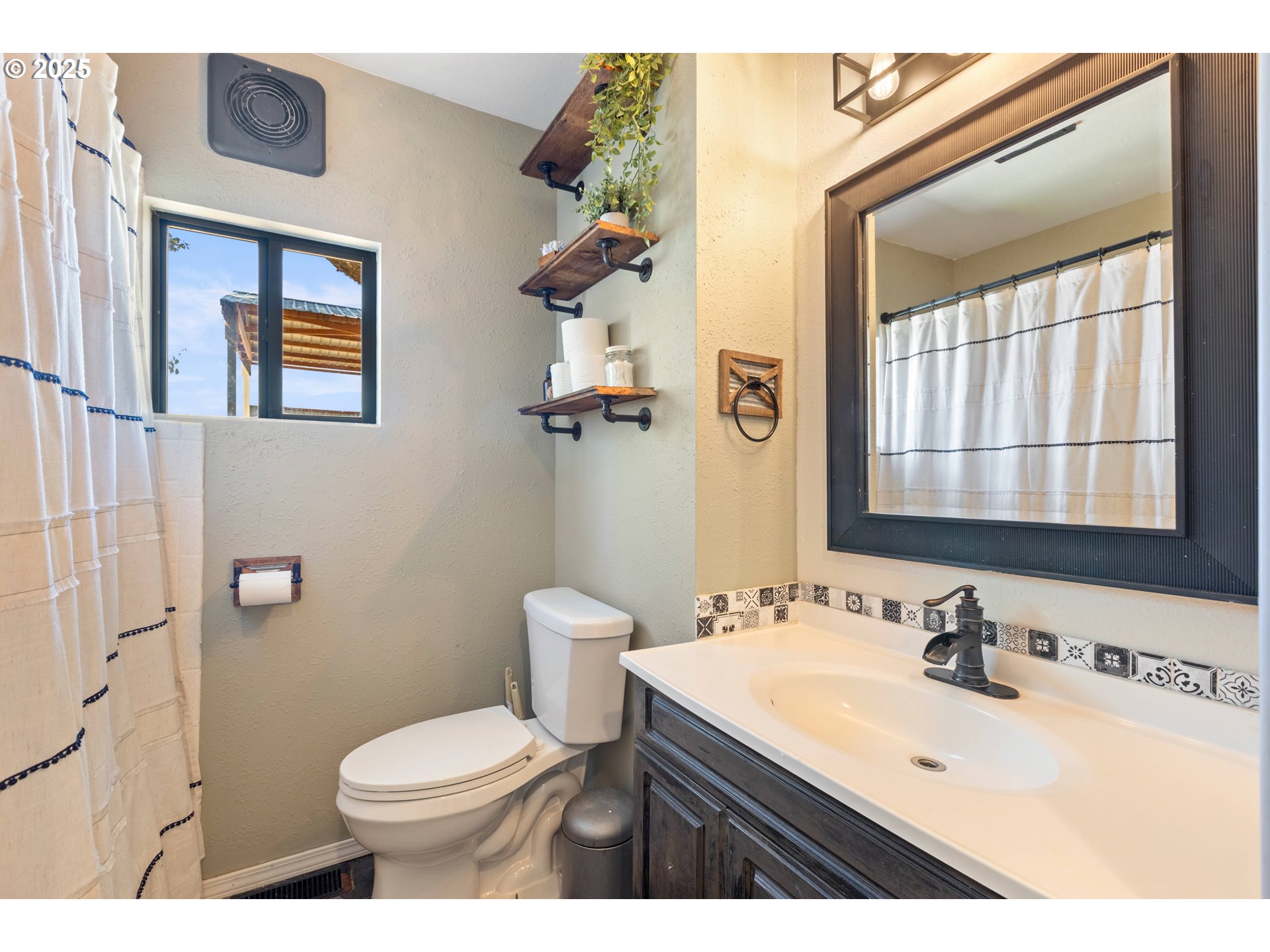 187 Hackett Lane Riddle, OR 97469 - Photo 19 of 48 a bathroom with a sink a toilet and mirror