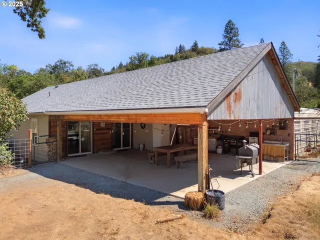 a view of a backyard with furniture and a roof
