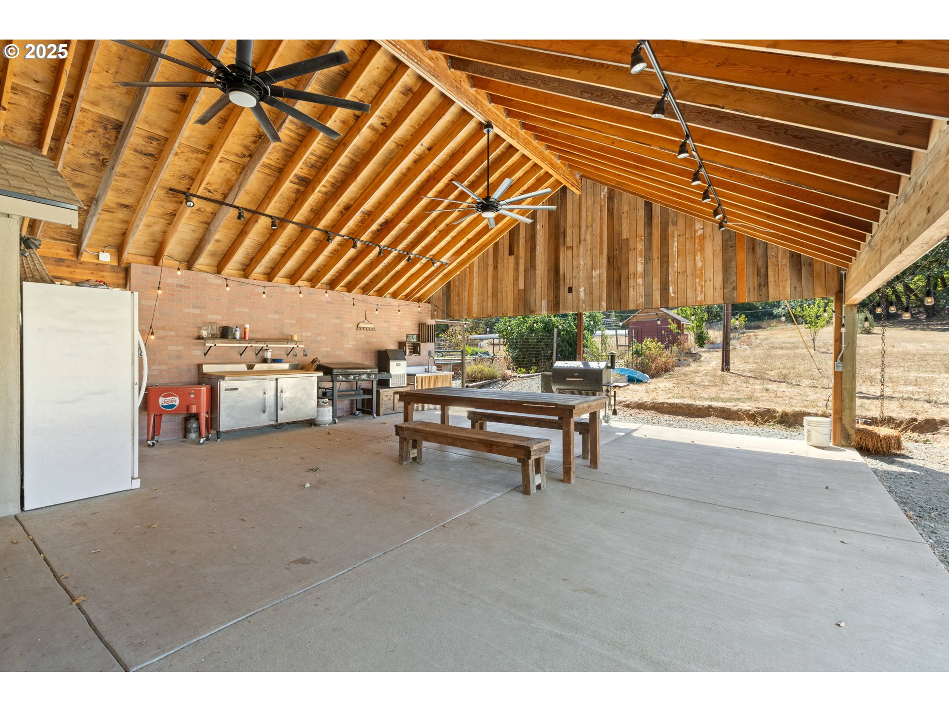 187 Hackett Lane Riddle, OR 97469 - Photo 25 of 48 a view of a patio with table and chairs under an umbrella
