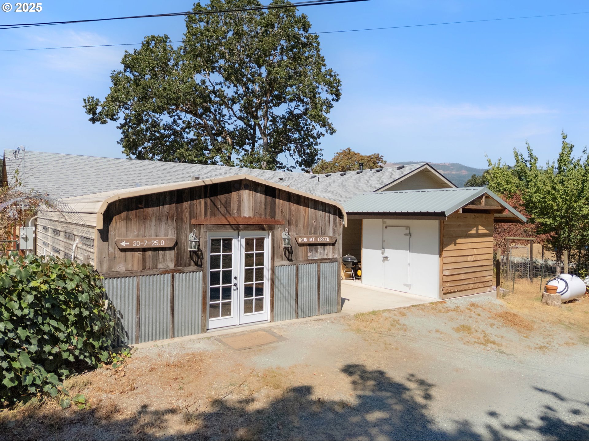 187 Hackett Lane Riddle, OR 97469 - Photo 26 of 48 a front view of a house with a yard and garage