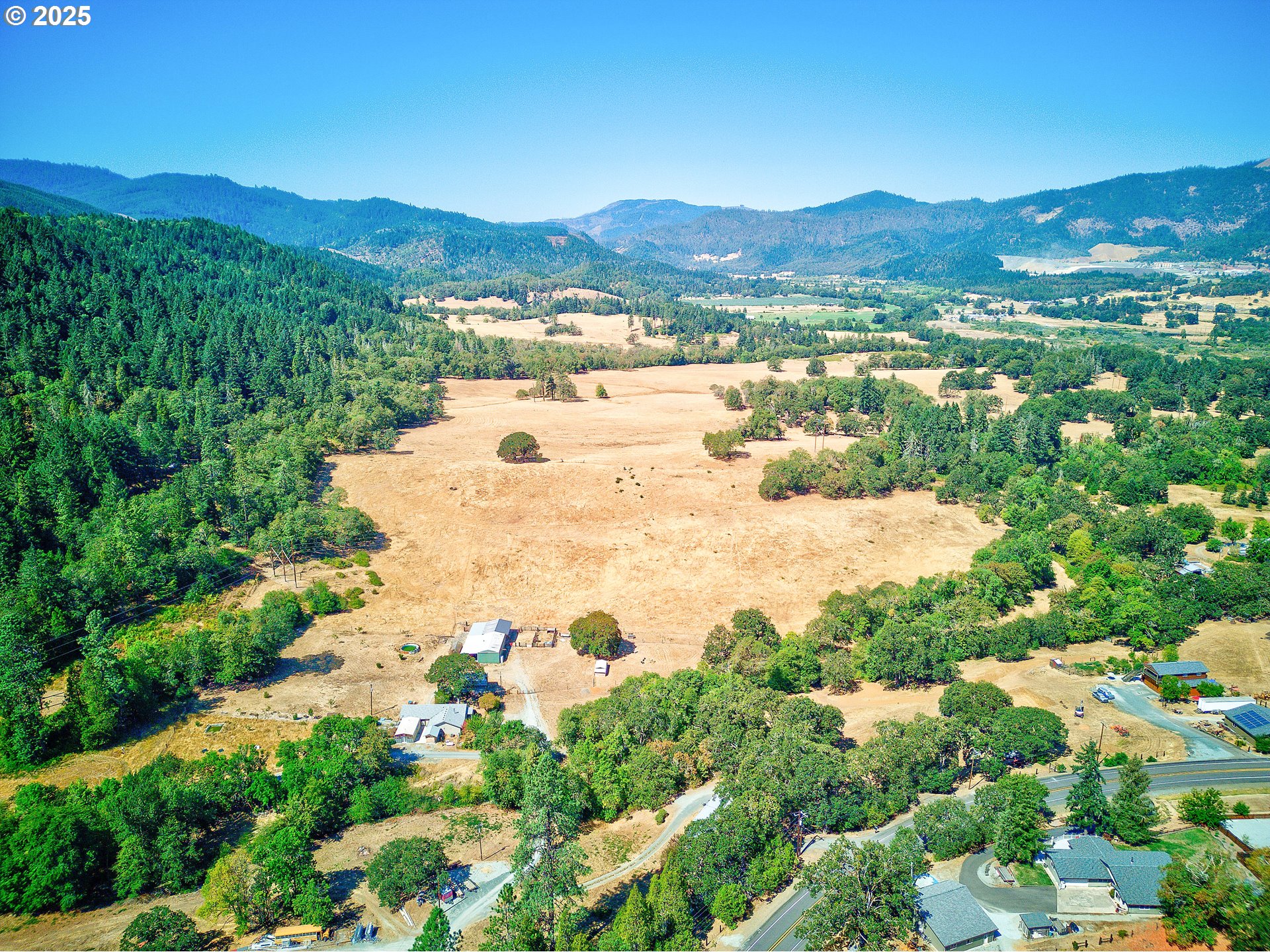 187 Hackett Lane Riddle, OR 97469 - Photo 46 of 48 a view of a city with mountains in the background