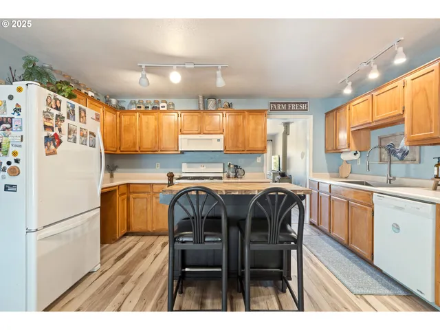 a kitchen with a refrigerator and a sink