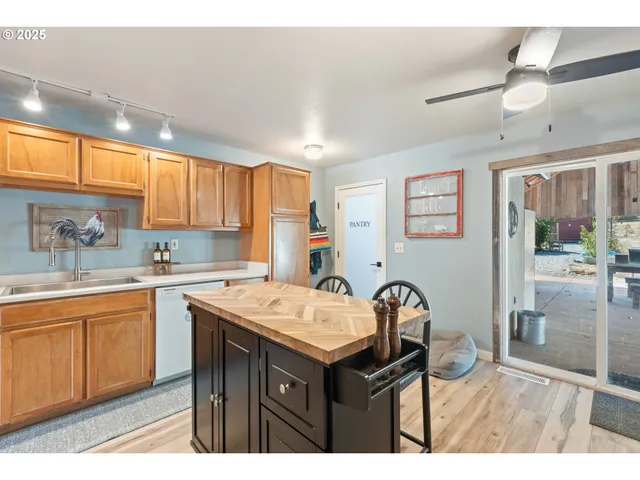 a kitchen with a sink a stove and chairs
