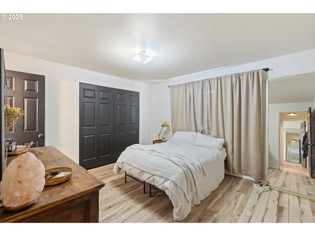 a bedroom with a bed and a large mirror