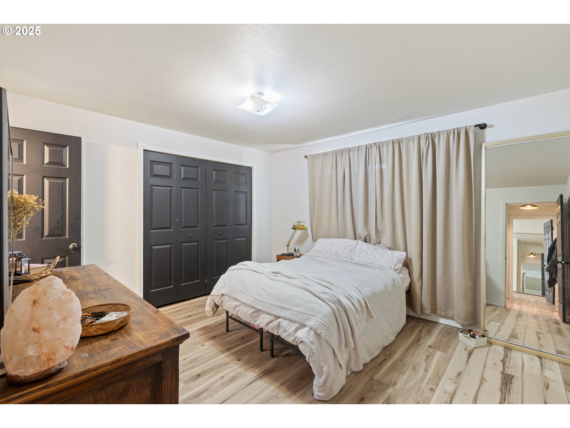 187 Hackett Lane Riddle, OR 97469 - Photo 10 of 48 a bedroom with a bed and a large mirror