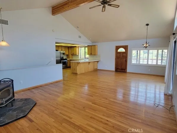 a view of a livingroom with furniture hardwood floor and a ceiling fan