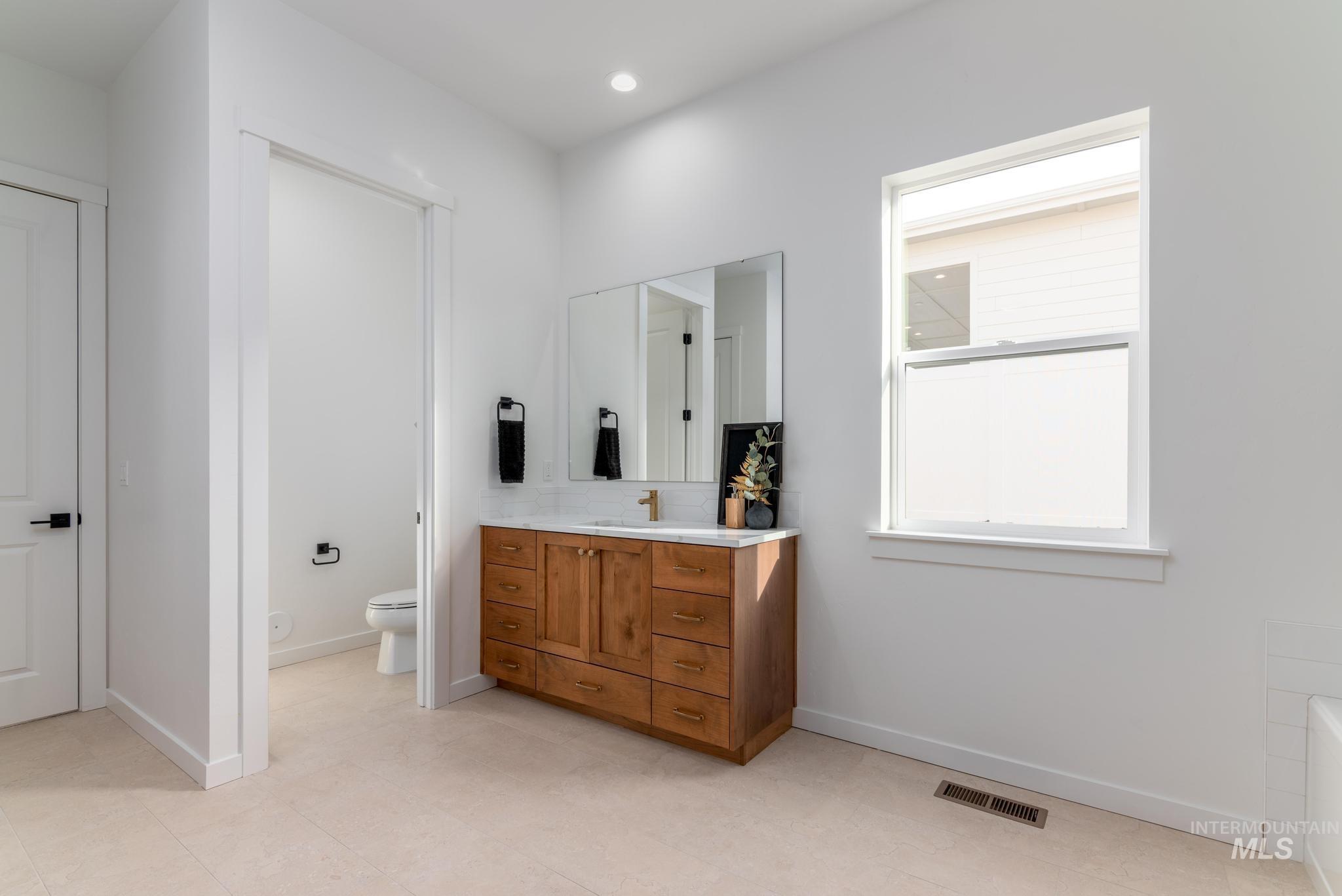 14702 Port Royal Street Caldwell, ID 83607 - Photo 19 of 39 Full bathroom featuring vanity, a tub, and recessed lighting