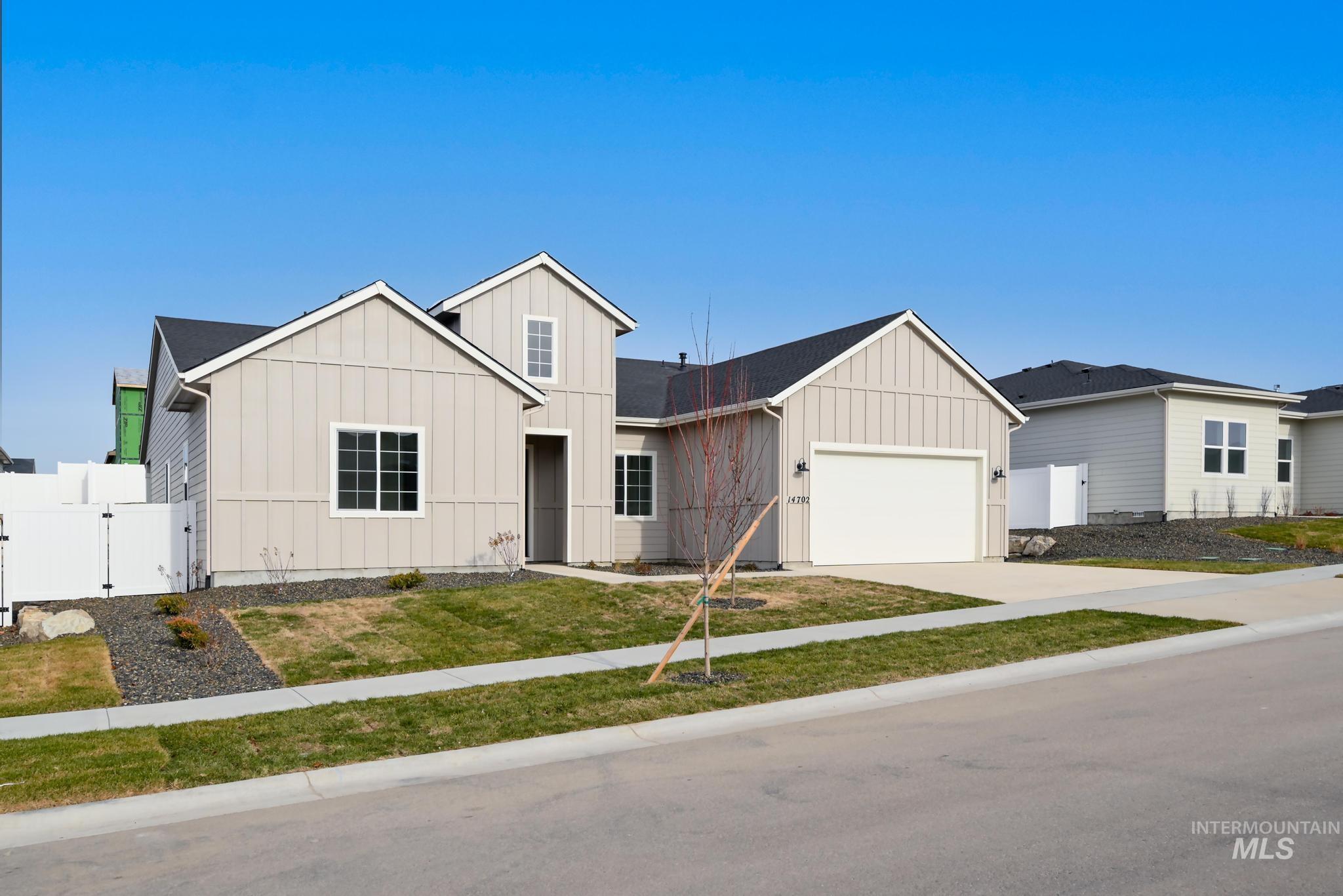 14702 Port Royal Street Caldwell, ID 83607 - Photo 2 of 39 View of front of property featuring board and batten siding, a gate, driveway, and an attached garage
