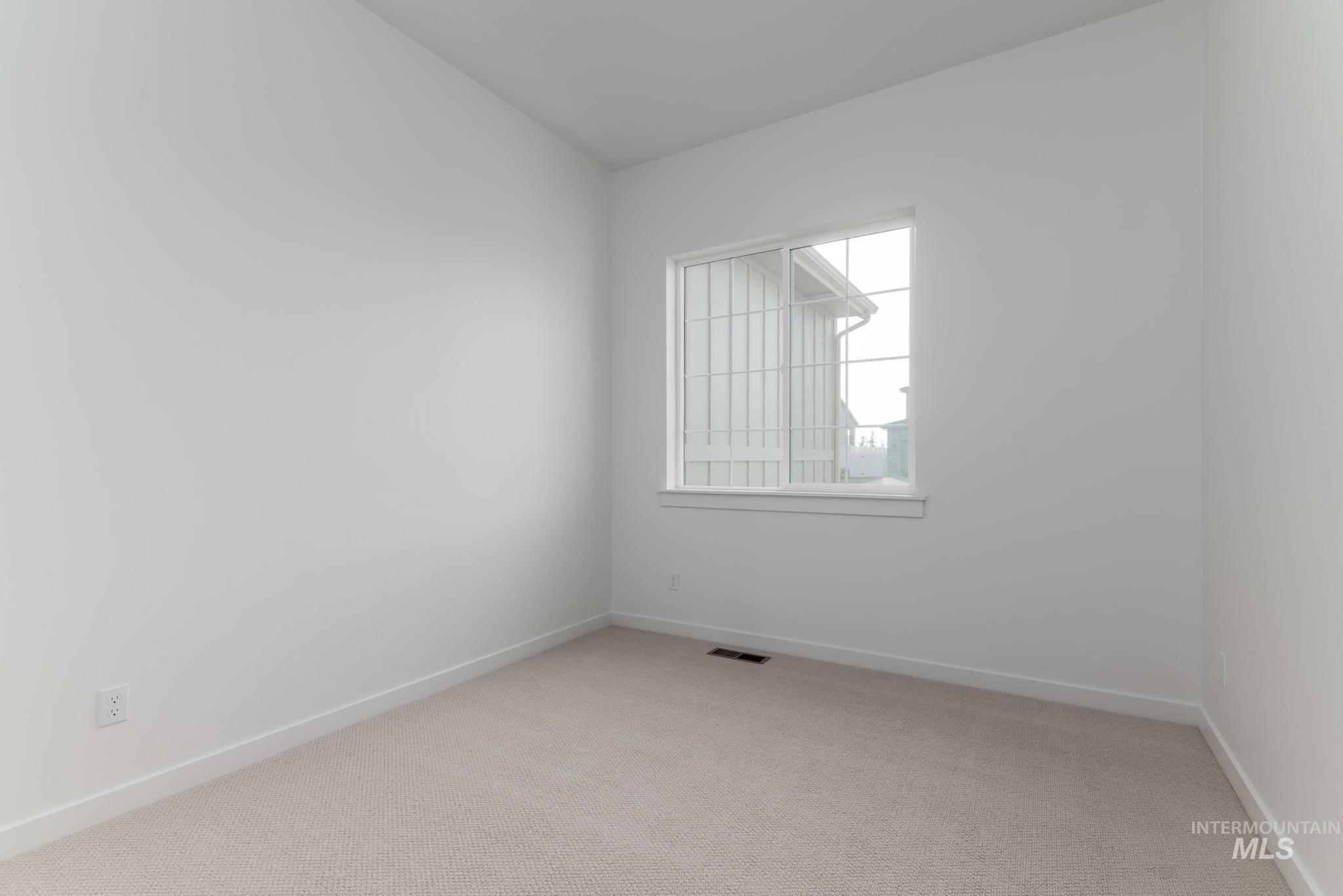 14702 Port Royal Street Caldwell, ID 83607 - Photo 21 of 39 Spare room with light colored carpet and baseboards