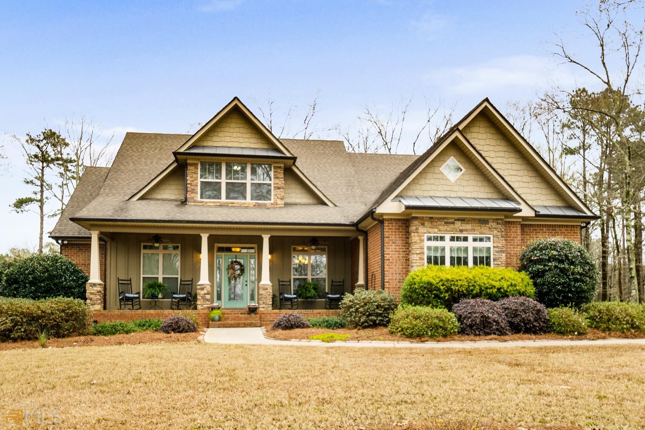 front view of brick house with a yard