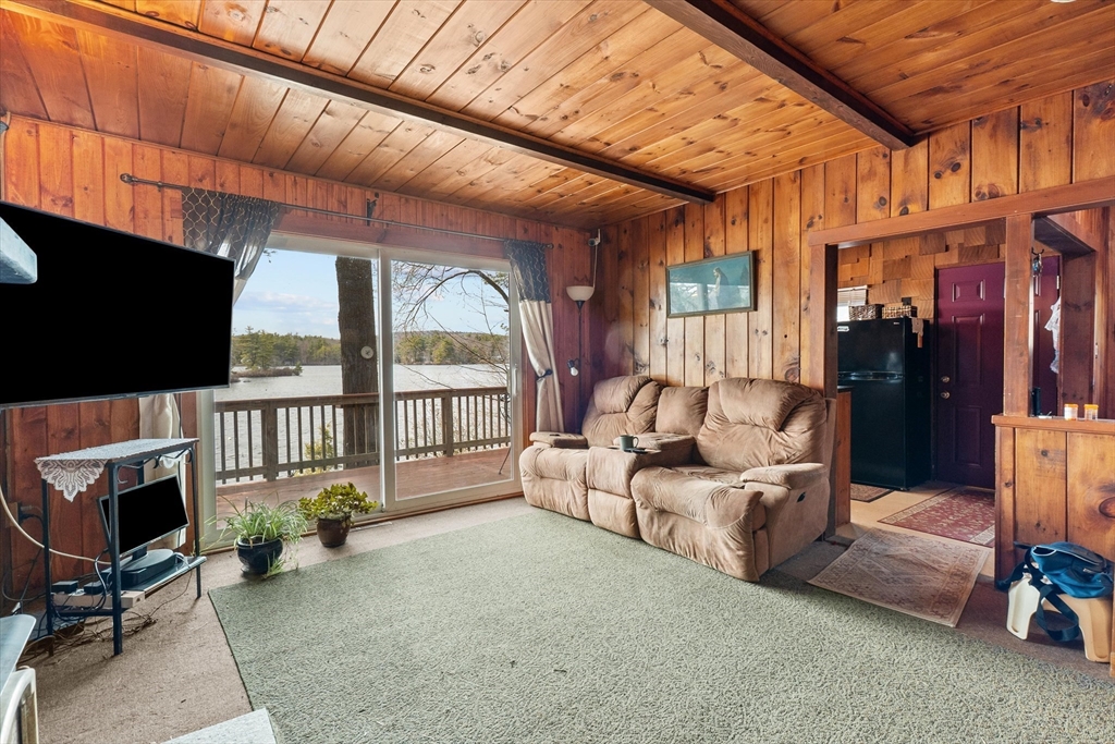 110 Stodge Meadow Road Ashburnham, MA 01430 - Photo 5 of 27 a living room with furniture a flat screen tv and a fireplace