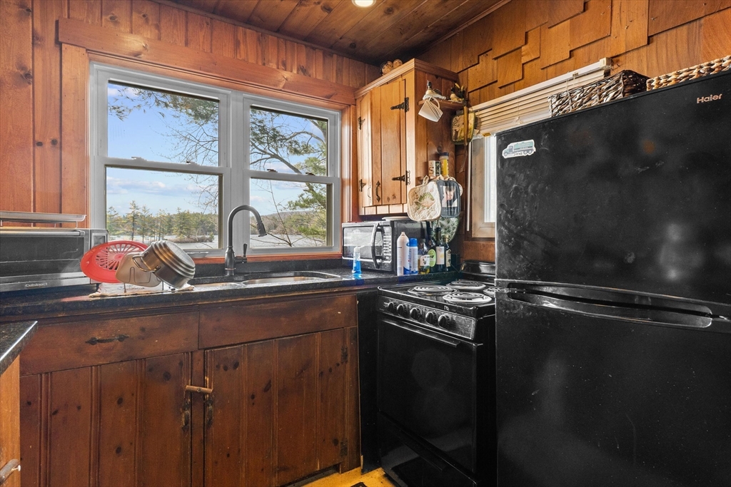 110 Stodge Meadow Road Ashburnham, MA 01430 - Photo 10 of 27 a kitchen with stainless steel appliances a sink window and cabinets