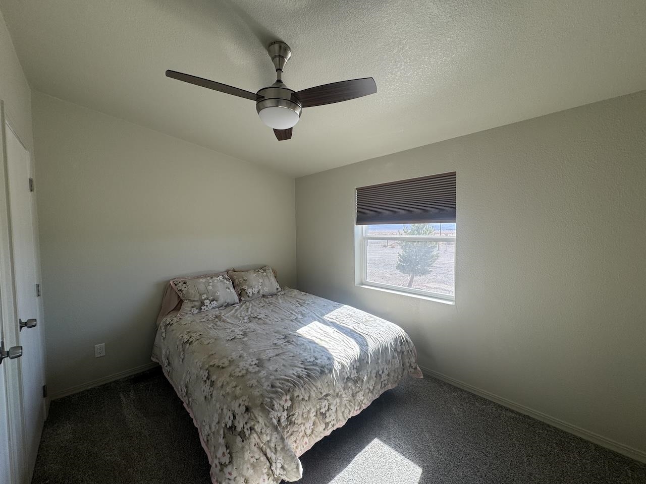 352 Wofford Road, Unit 4 Bishop, CA 93514 - Photo 20 of 40 Bedroom featuring ceiling fan, carpet floors, and a textured ceiling