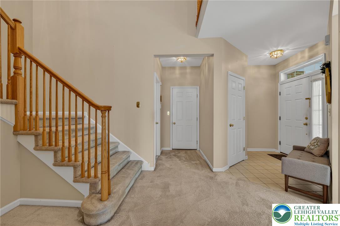 4345 Creek Road Allentown, PA 18104 - Photo 7 of 33 A graceful staircase with wood railings guides the eye through this welcoming entryway.