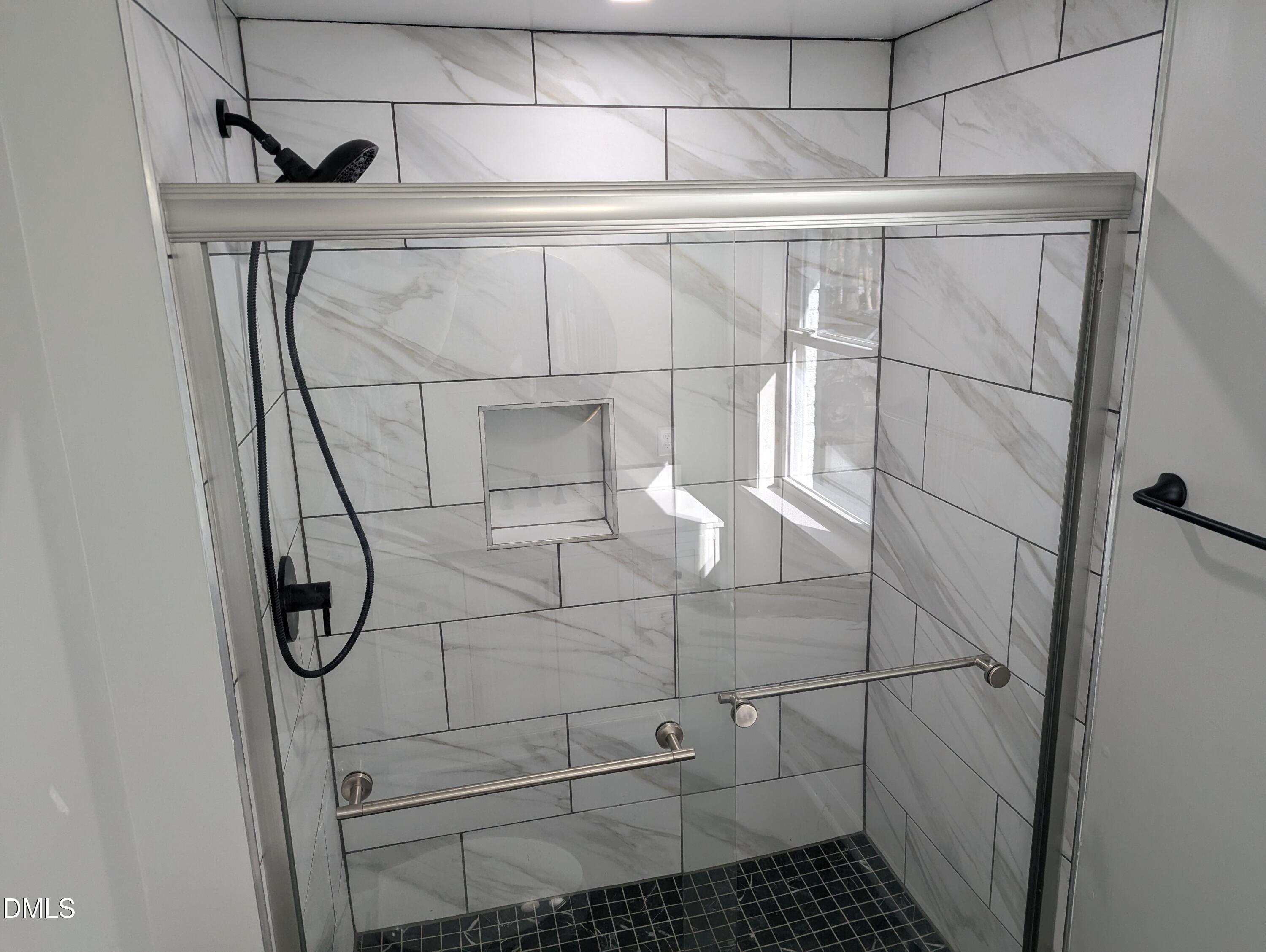 4011 Garrett Road Durham, NC 27707 - Photo 14 of 21 a bathroom with a glass shower door