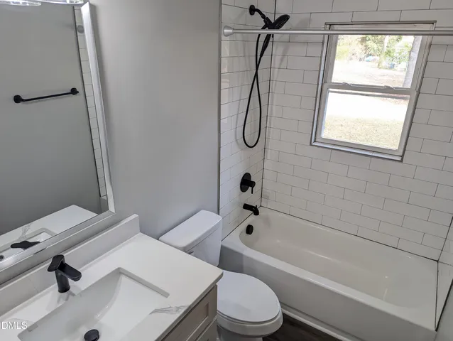 a bathroom with a sink a toilet and a bathtub
