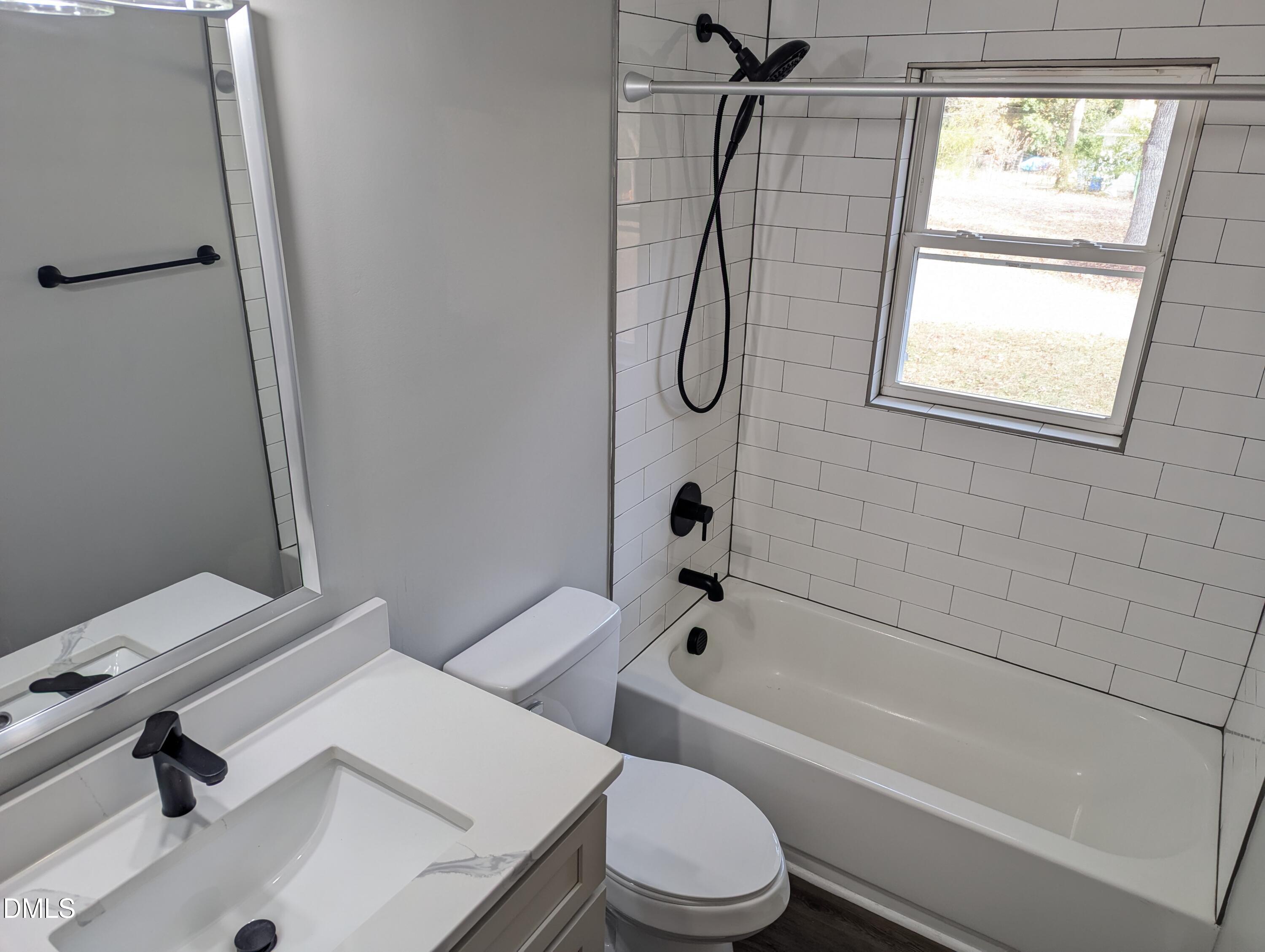 4011 Garrett Road Durham, NC 27707 - Photo 15 of 21 a bathroom with a sink a toilet and a bathtub