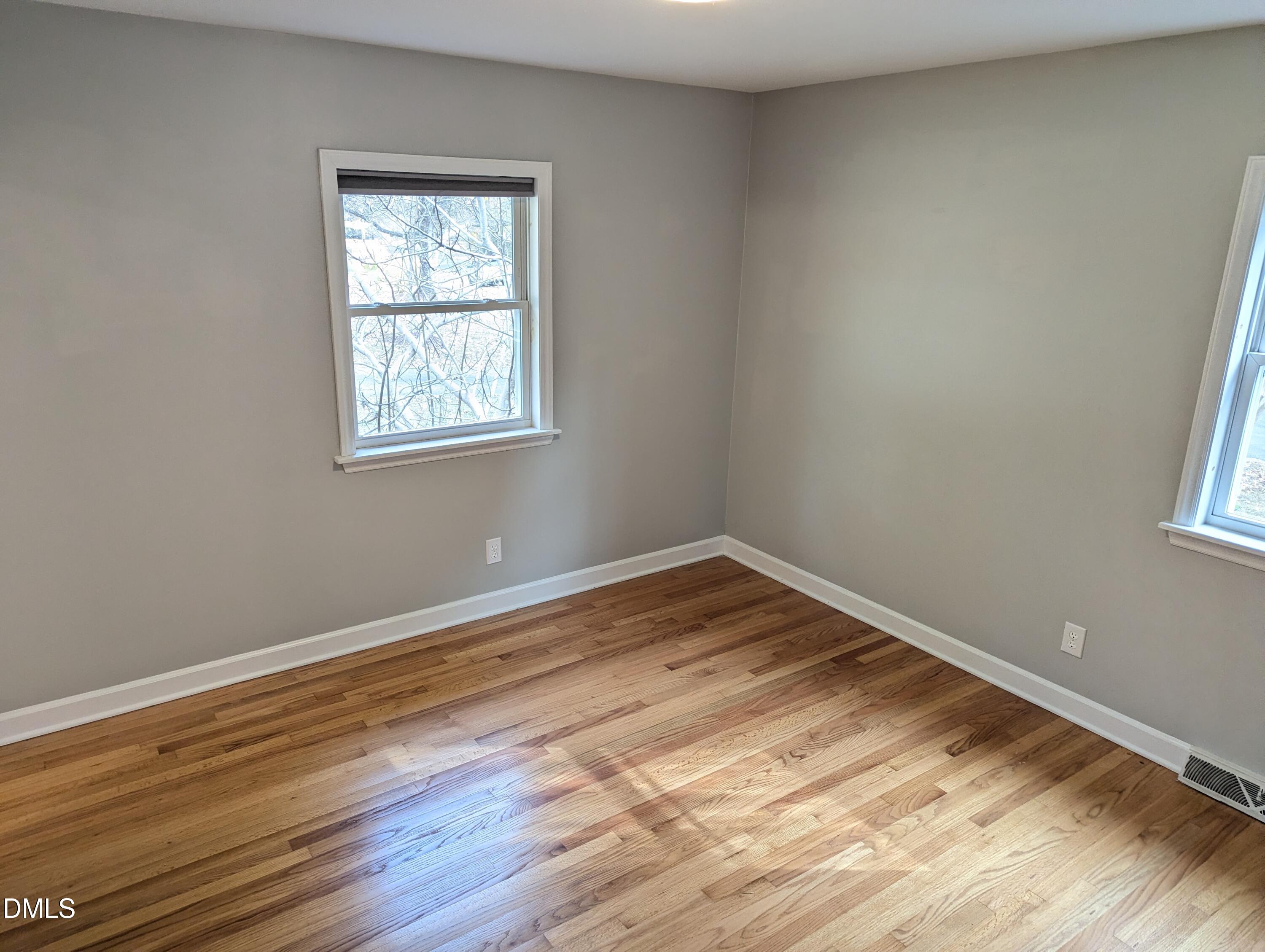 4011 Garrett Road Durham, NC 27707 - Photo 18 of 21 an empty room with wooden floor and windows