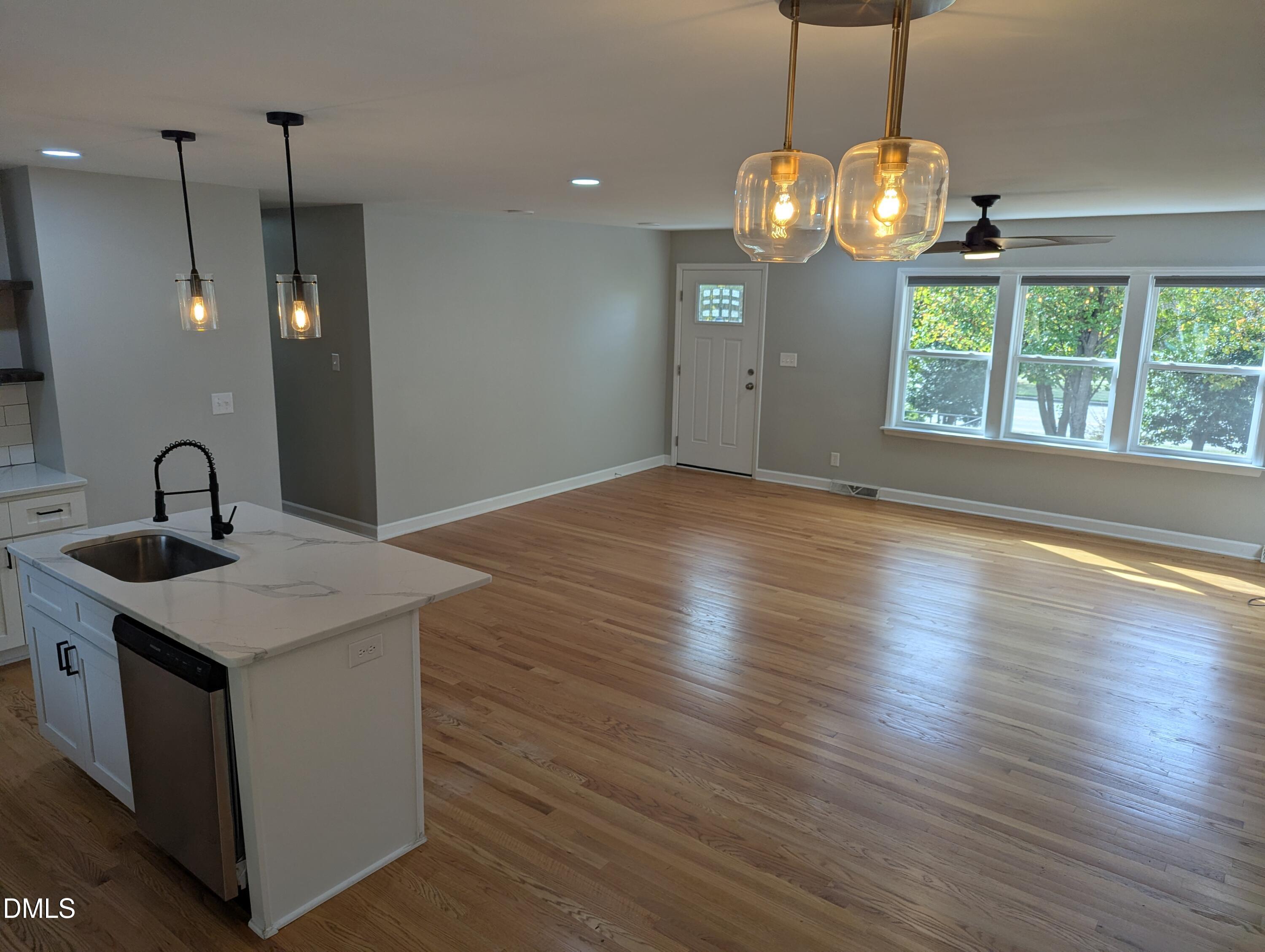 4011 Garrett Road Durham, NC 27707 - Photo 7 of 21 a view of a kitchen with wooden floor and a sink