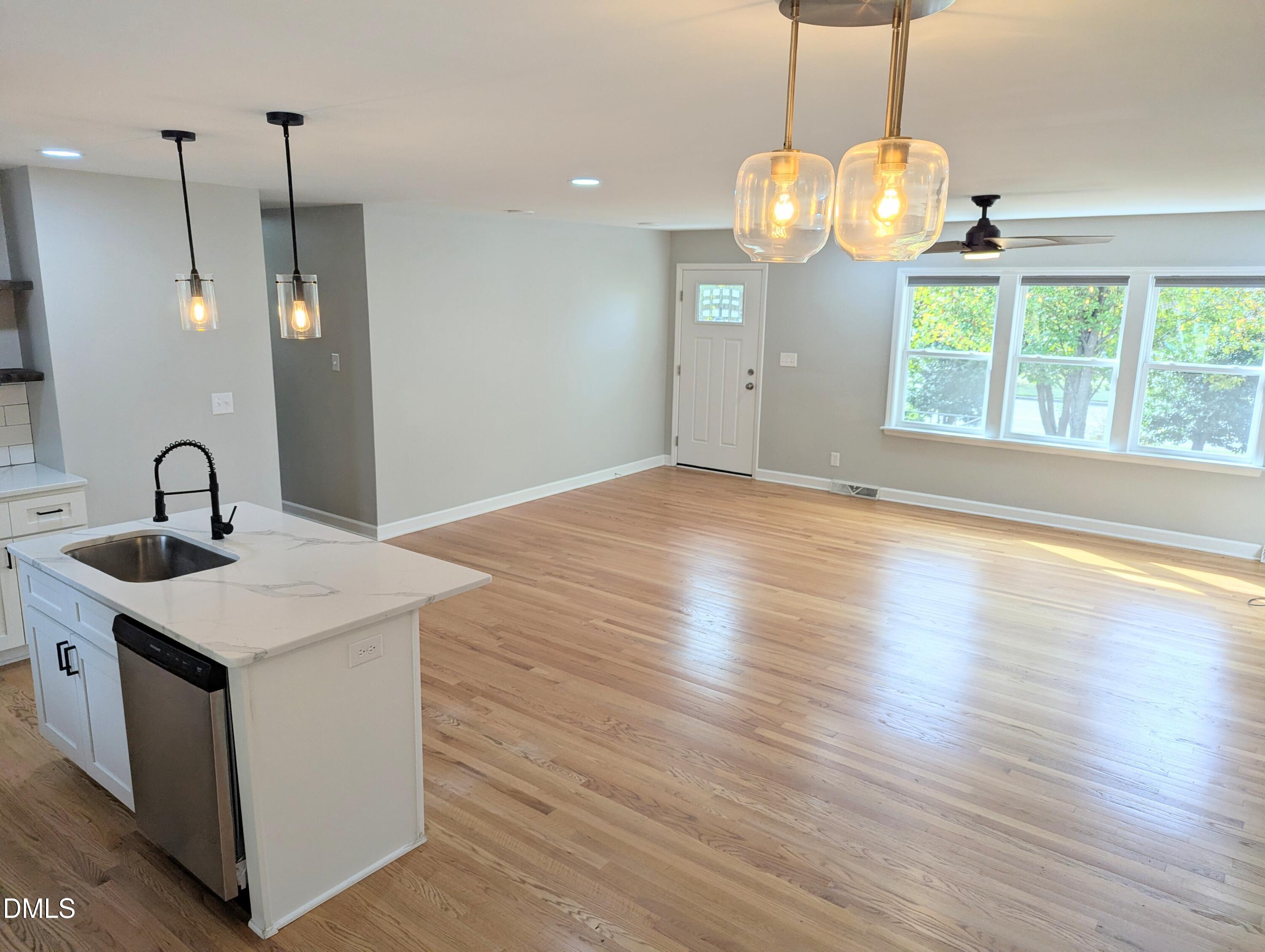 4011 Garrett Road Durham, NC 27707 - Photo 8 of 21 a view of a kitchen with a sink wooden floor and a chandelier