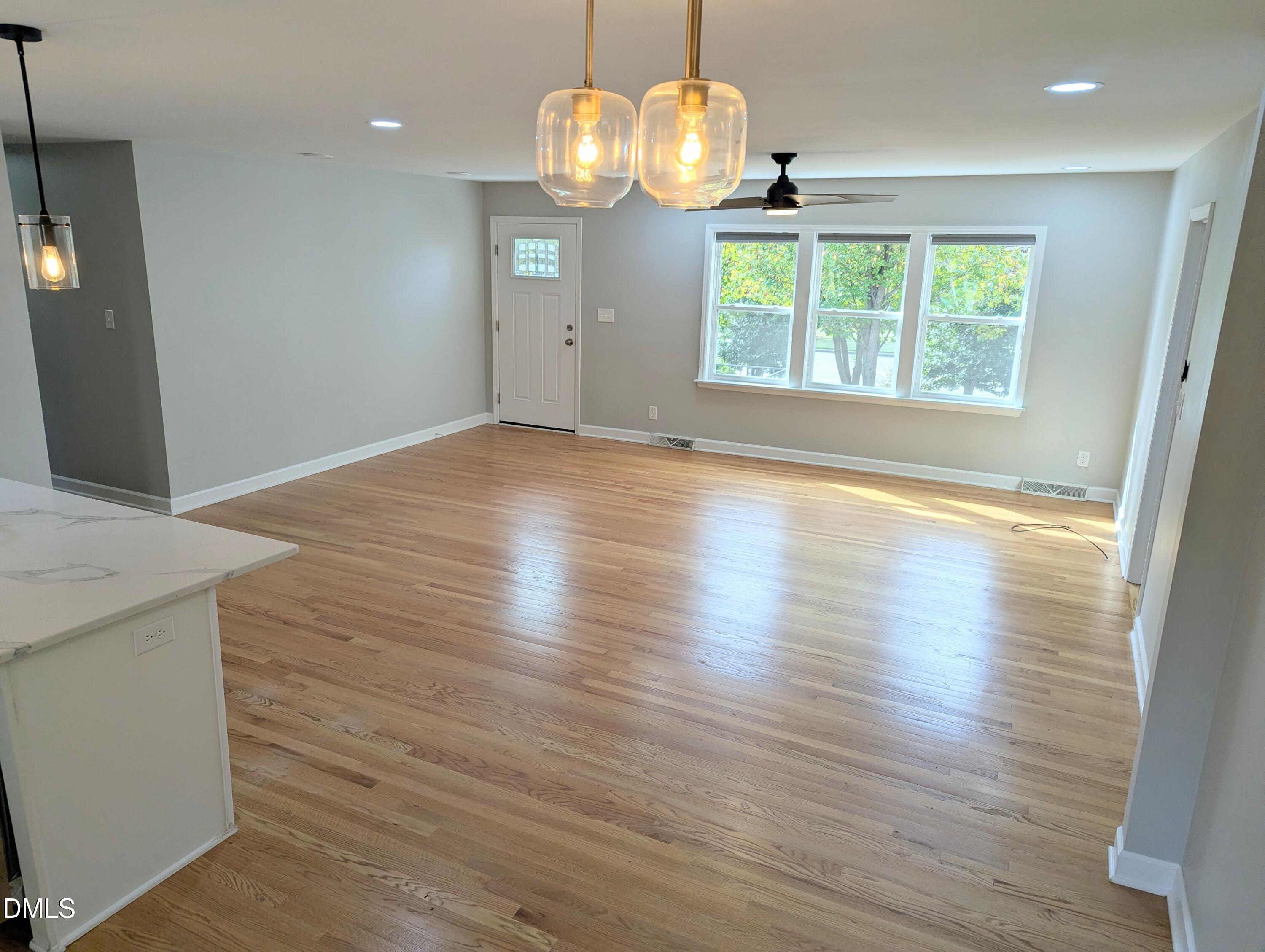 4011 Garrett Road Durham, NC 27707 - Photo 9 of 21 an empty room with wooden floor and windows
