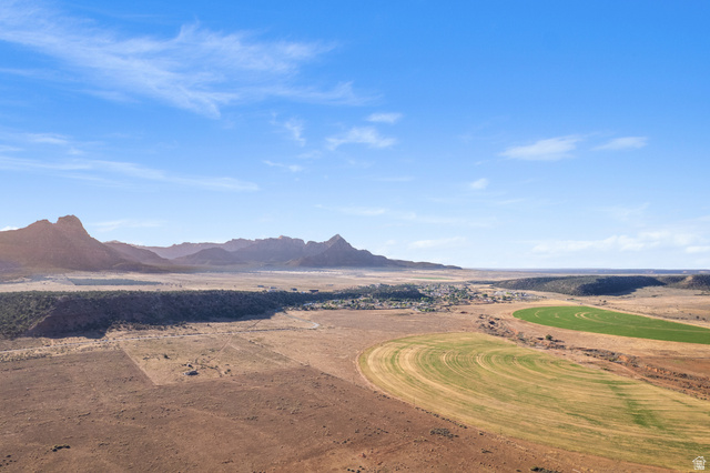 Gooseberry Way Apple Valley, UT 84737 - Photo 19 of 24 Expansive desert landscape featuring distant mountain ranges, a central village, and circular agricultural fields