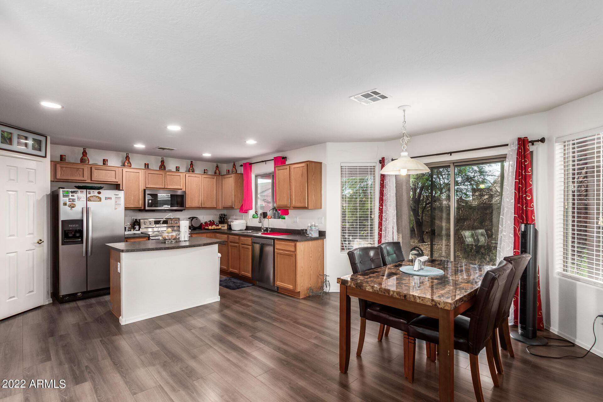 3790 West South Butte Road Queen Creek, AZ 85144 - Photo 11 of 40 a kitchen with a dining table chairs and refrigerator