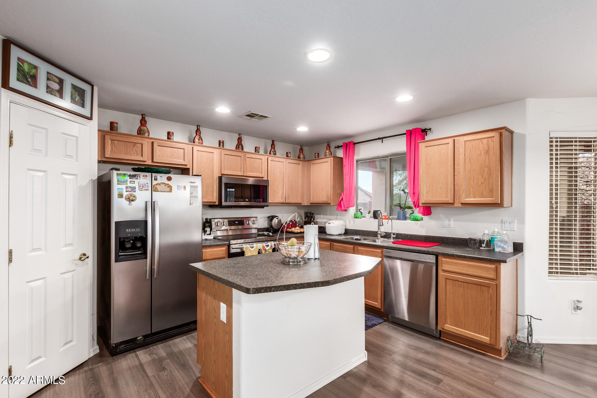 3790 West South Butte Road Queen Creek, AZ 85144 - Photo 12 of 40 a kitchen with stainless steel appliances granite countertop a refrigerator a sink a stove a microwave and wooden floor