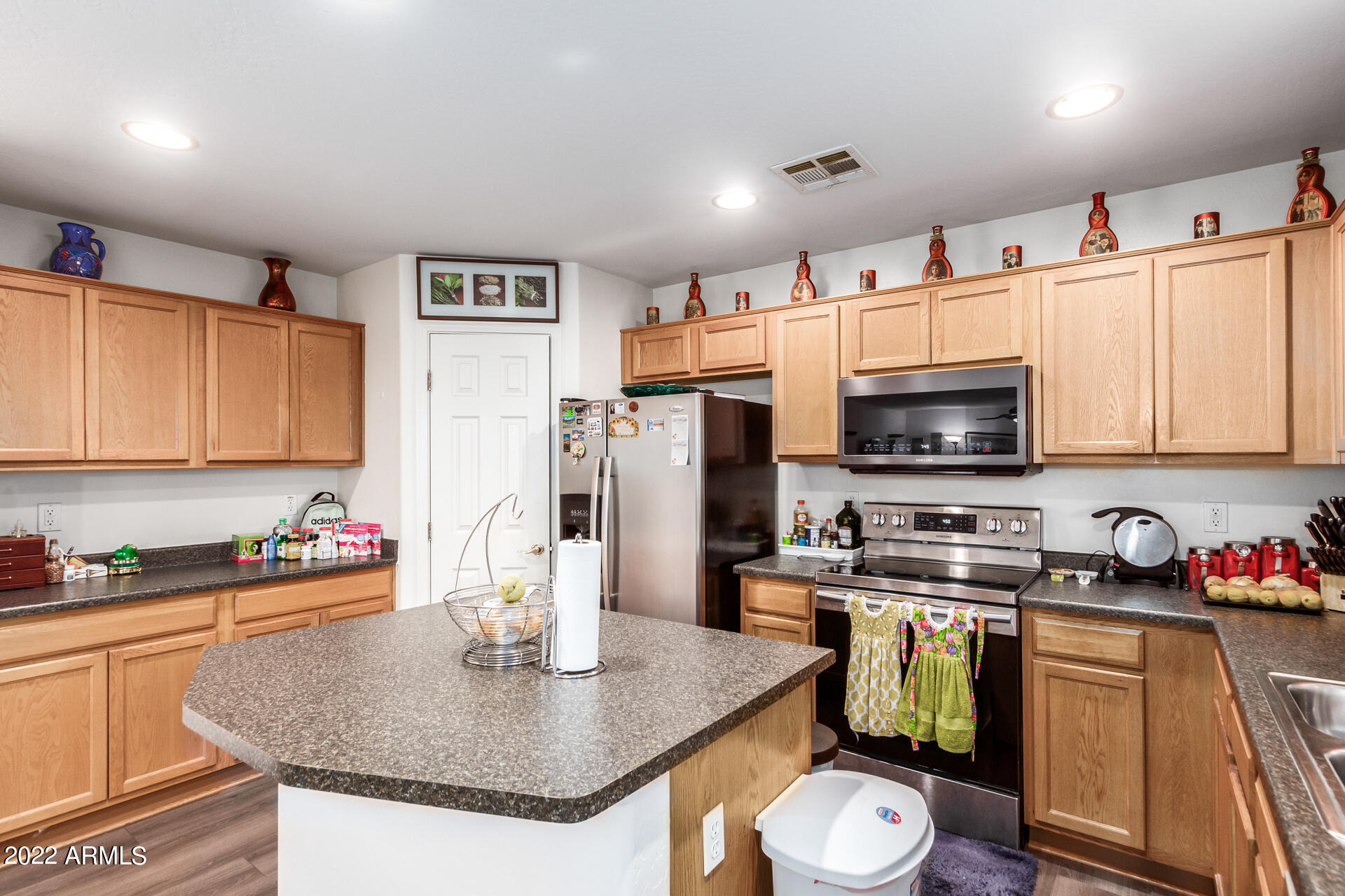 3790 West South Butte Road Queen Creek, AZ 85144 - Photo 14 of 40 a kitchen with stainless steel appliances granite countertop a sink a stove and refrigerator
