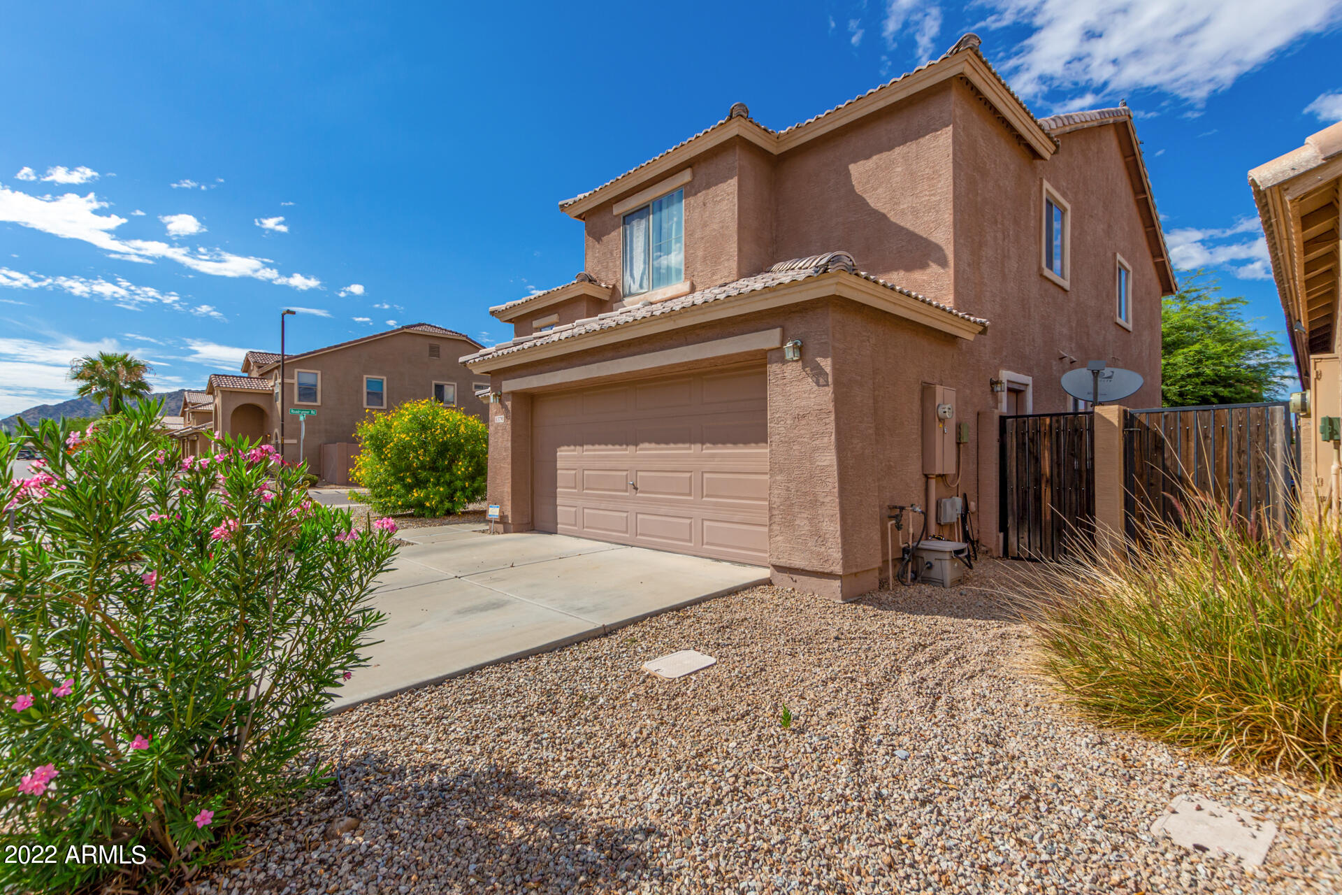 3790 West South Butte Road Queen Creek, AZ 85144 - Photo 2 of 40 a front view of a house with a yard and garage