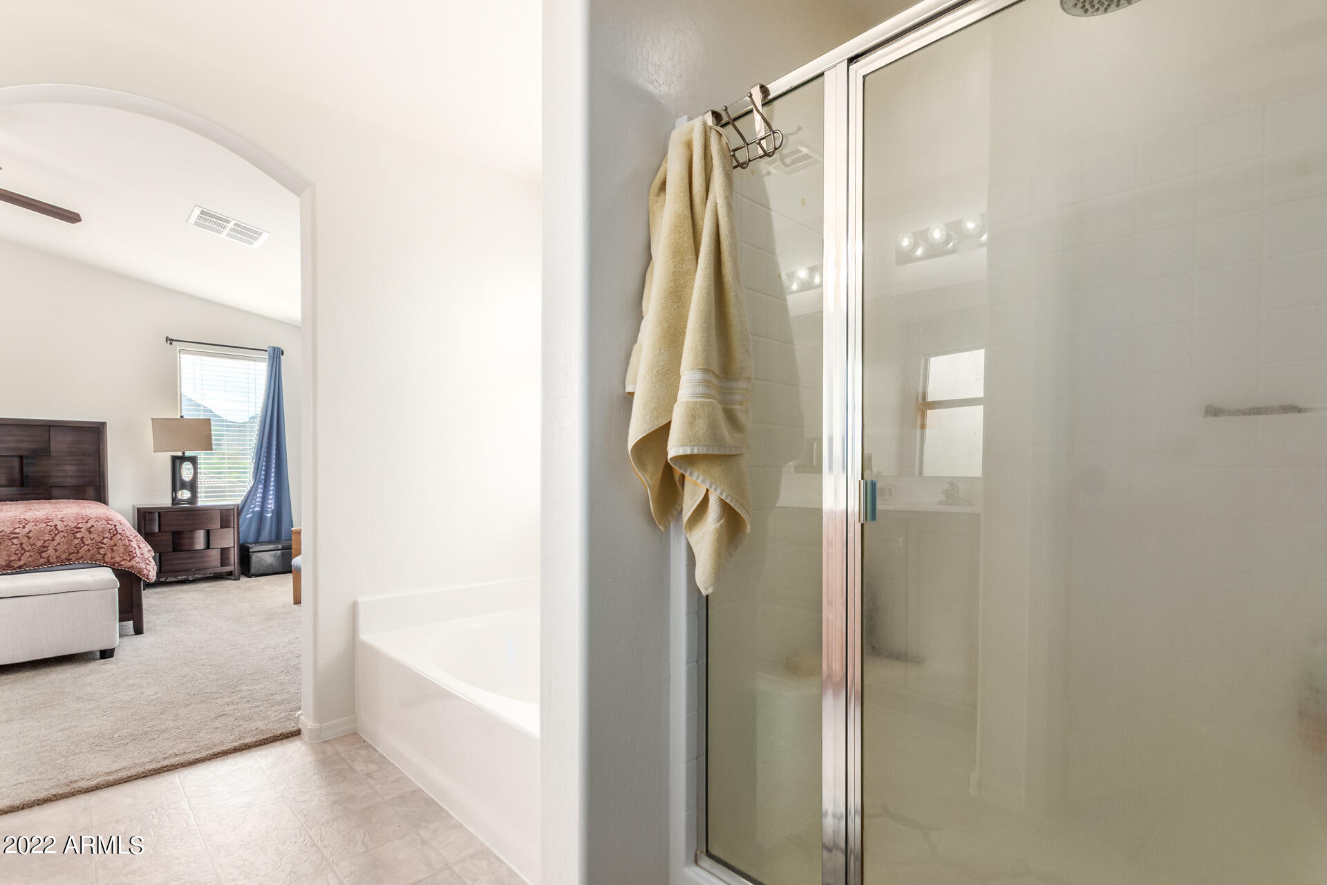 3790 West South Butte Road Queen Creek, AZ 85144 - Photo 22 of 40 a en suite bathroom with a tub shower and a sink