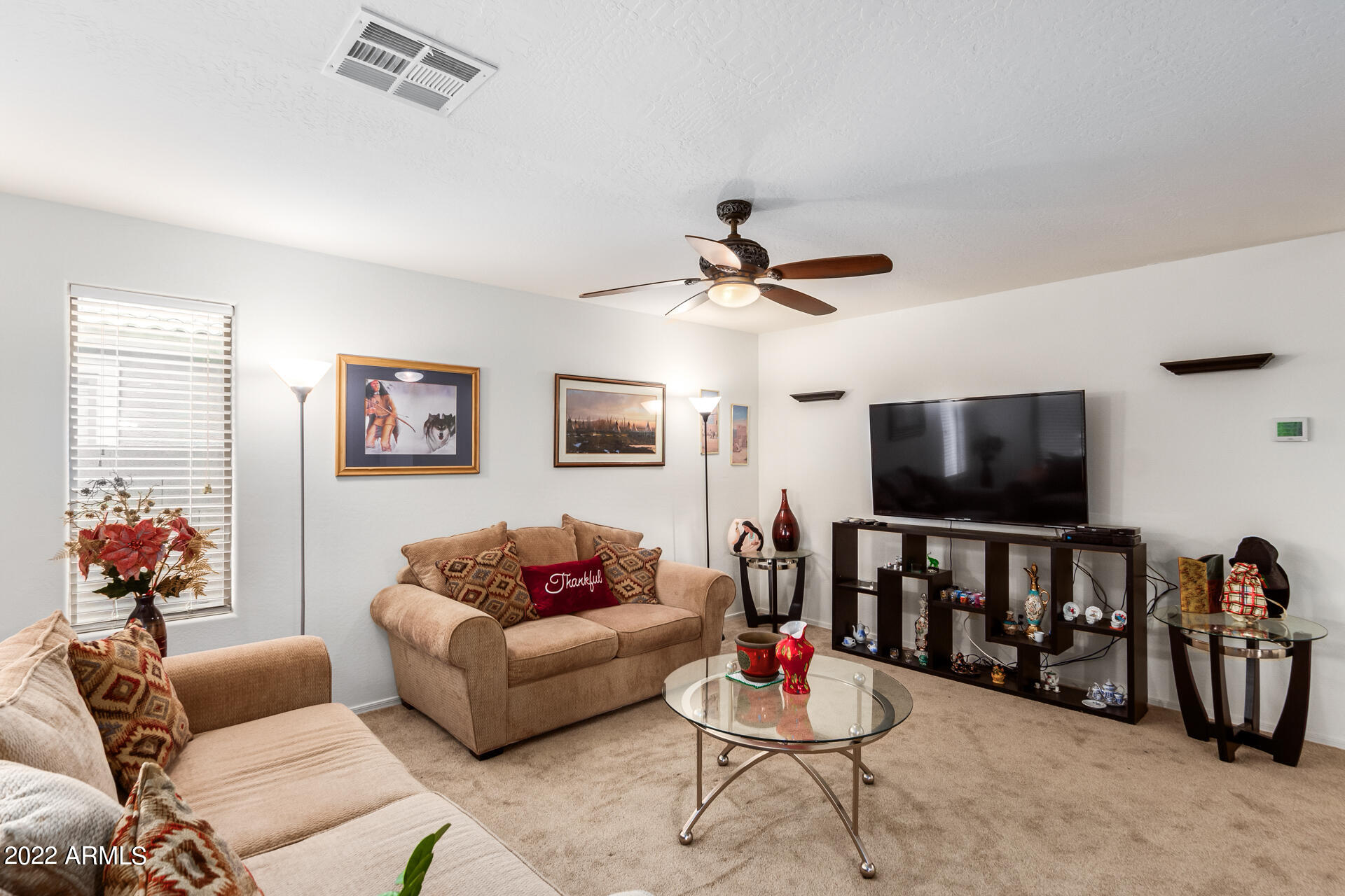 3790 West South Butte Road Queen Creek, AZ 85144 - Photo 9 of 40 a living room with furniture and a flat screen tv