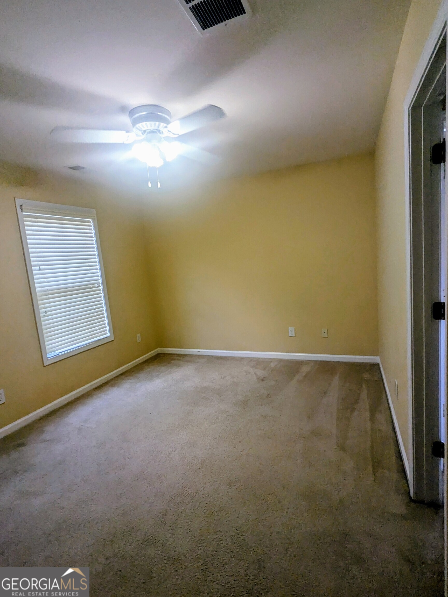 137 Village Green Circle Tyrone, GA 30290 - Photo 15 of 30 an empty room with a empty space and windows