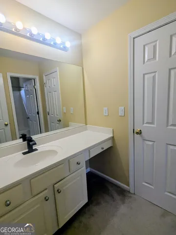 a bathroom with a double vanity sink and a mirror
