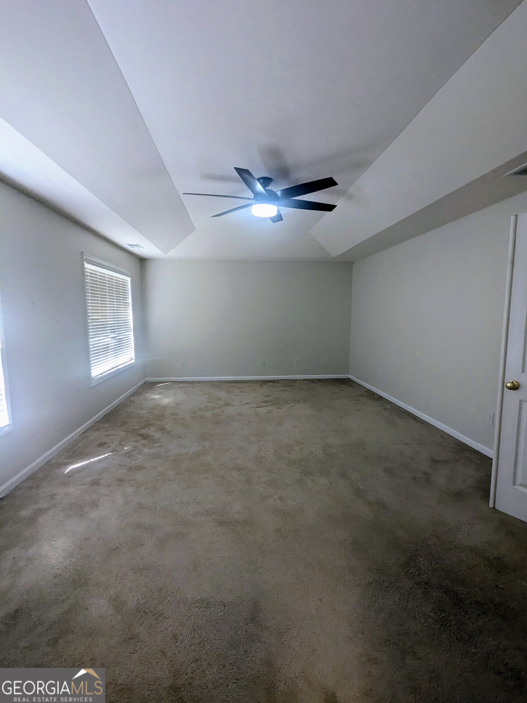 137 Village Green Circle Tyrone, GA 30290 - Photo 20 of 30 an empty room with windows and fan