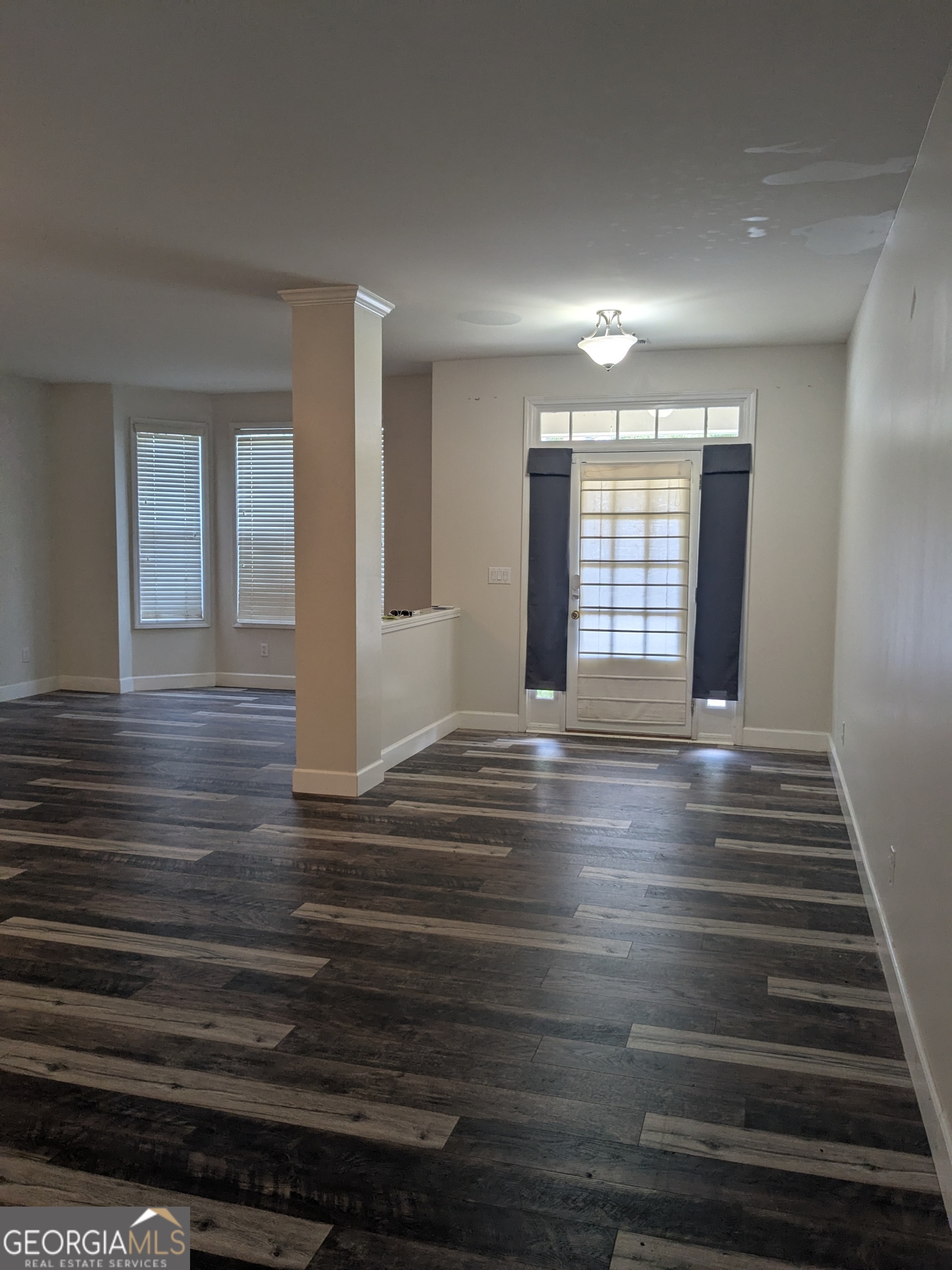 137 Village Green Circle Tyrone, GA 30290 - Photo 2 of 30 a view of an empty room with wooden floor and a window