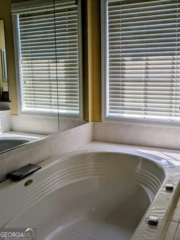 a view of a bathtub and window in a room