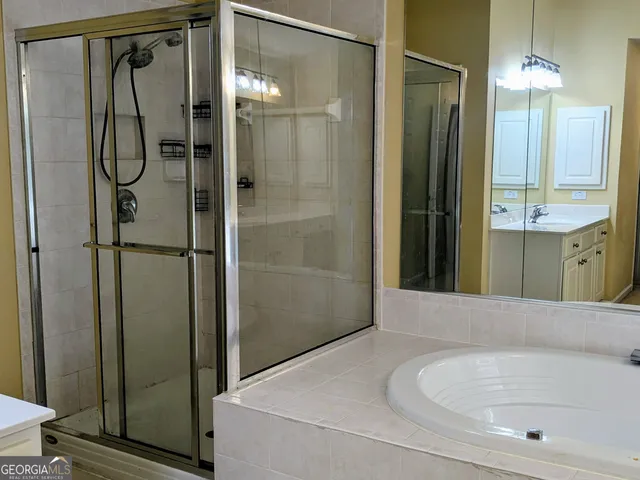 a bathroom with a tub and a shower