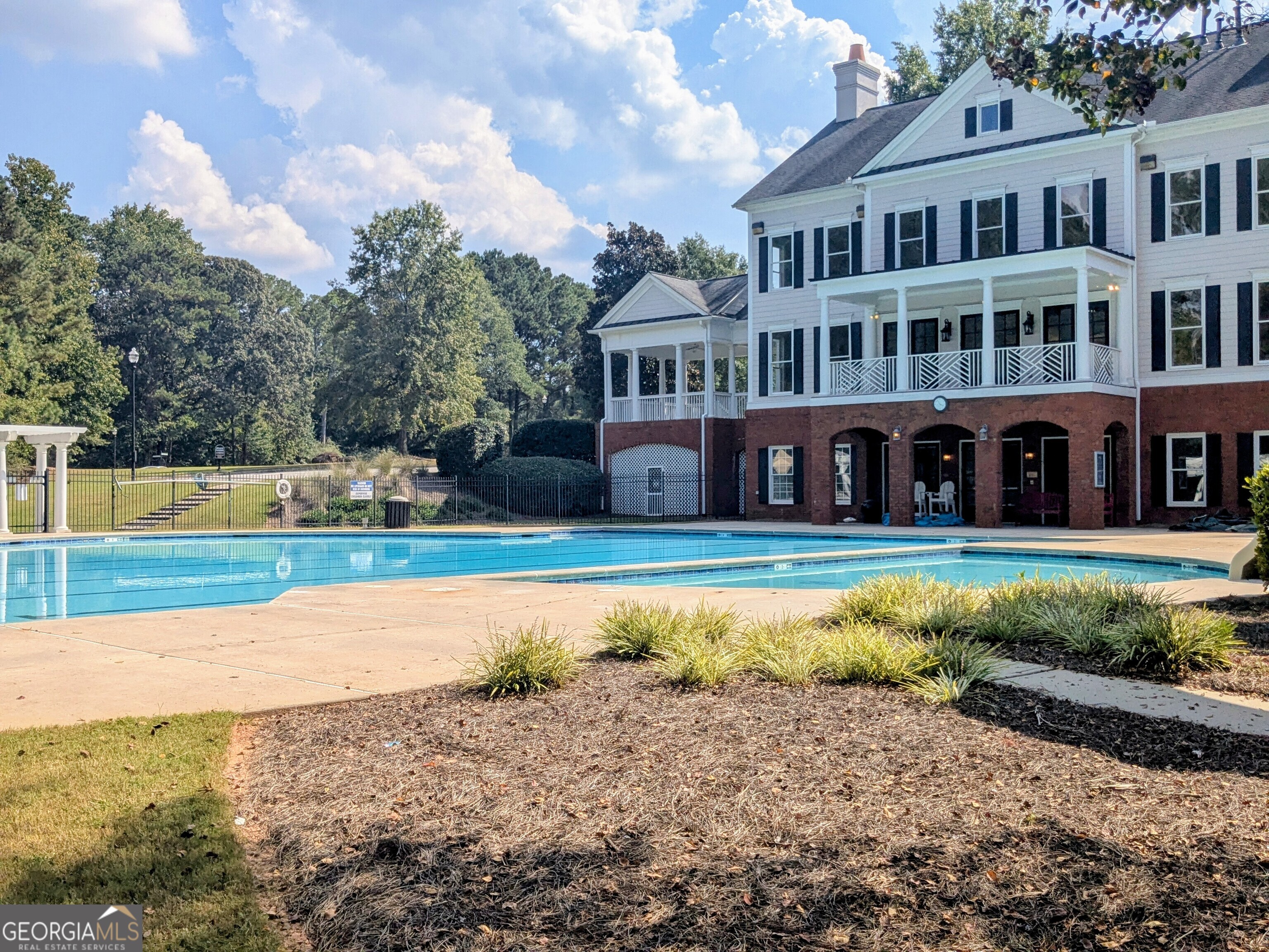 137 Village Green Circle Tyrone, GA 30290 - Photo 25 of 30 a view of a house with swimming pool and a yard