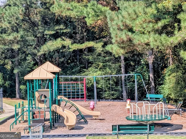 a view of a patio with a table chairs and a floor to ceiling window