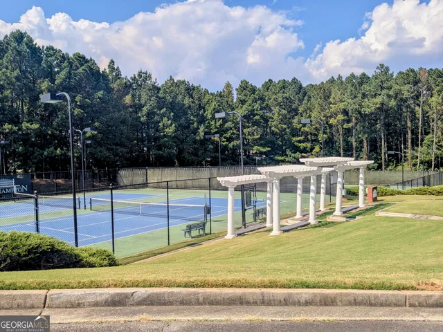 a view of a house with a swimming pool and a yard